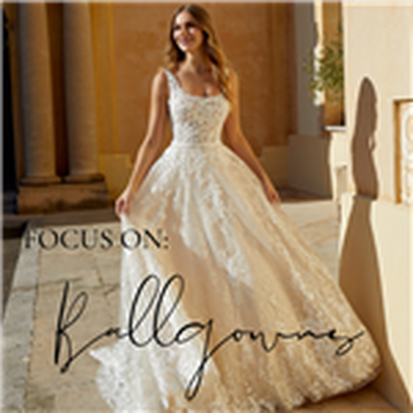 Designed image showing a close up of a model stood outside in the sun wearing a strappy lace ballgown wedding dress ‘Focus on ballgowns.’
